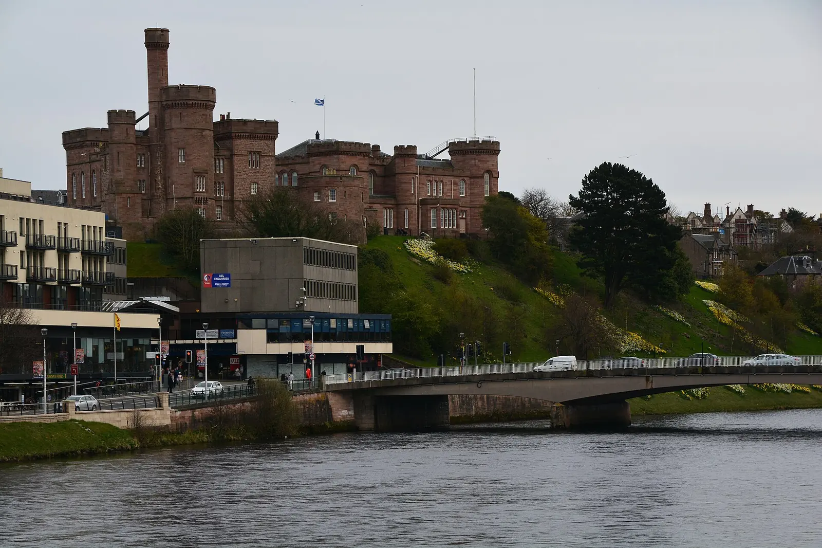 Inverness Castle, a red sandstone building with towers, above the River Ness and a road bridge
