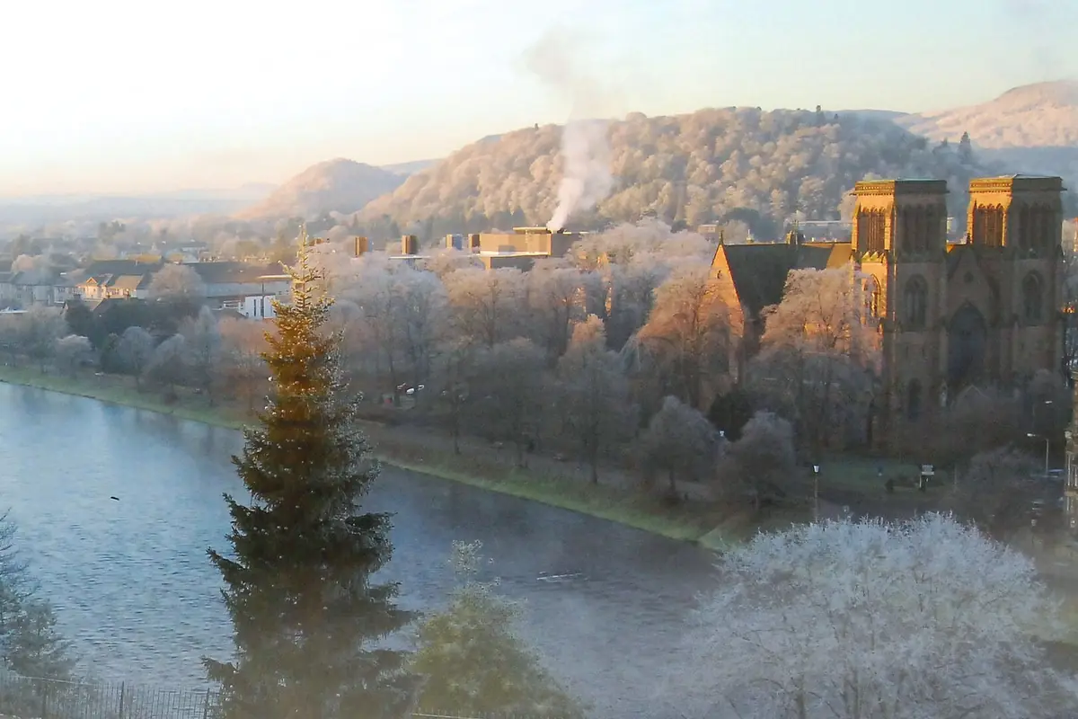 Inverness Cathedral's twin towers rising above frosted trees beside the River Ness on a winter morning